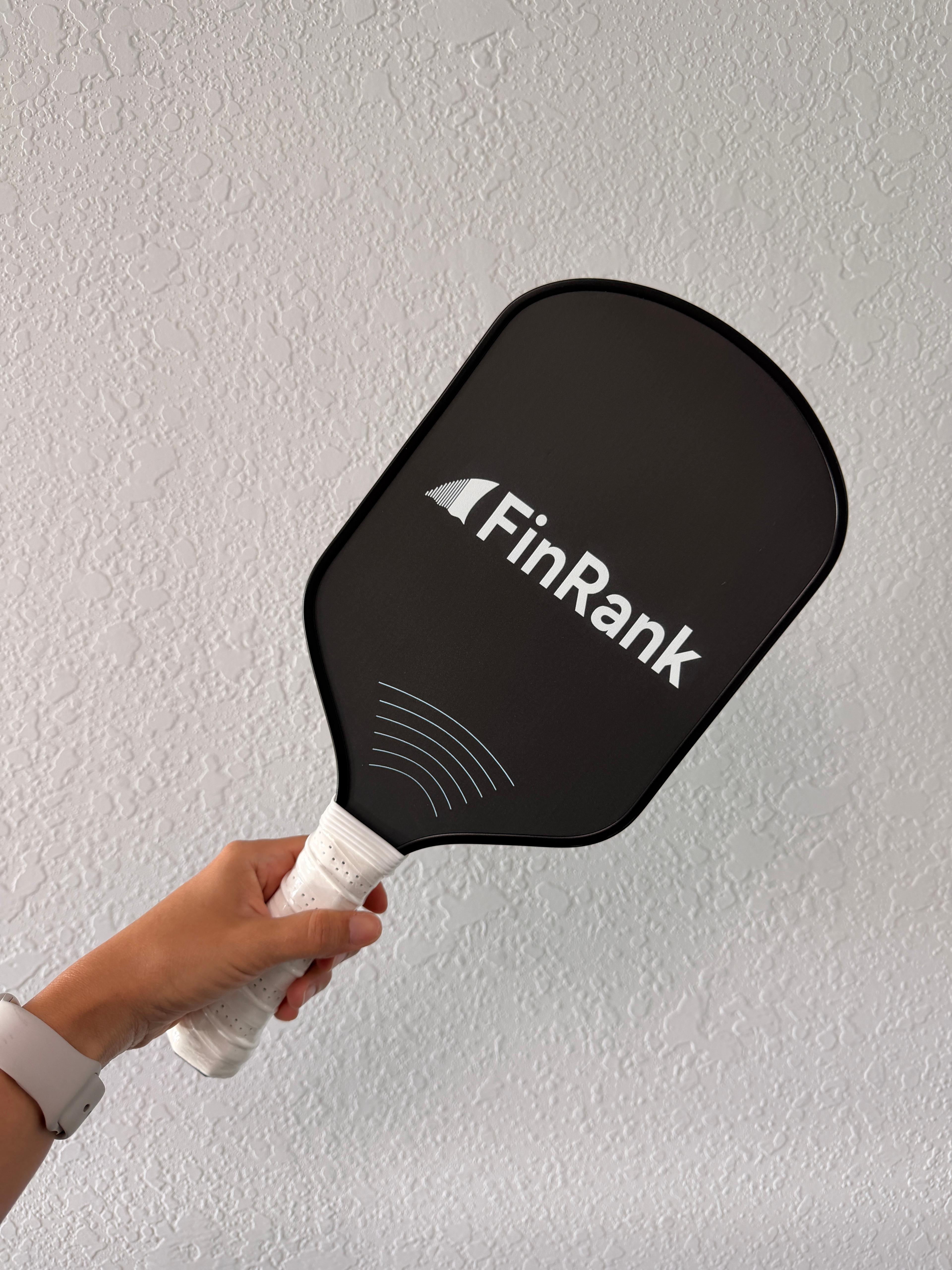 Custom FinRank carbon fiber pickleball paddle with a centered logo
